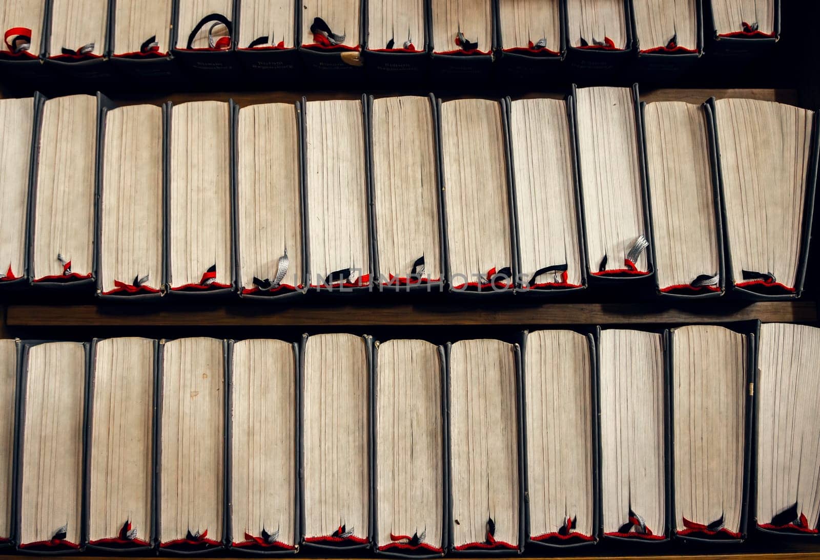 Stacked vintage books with worn edges and bookmarks, top view. Warm tones, academic and literary theme. ideal for literary and educational projects