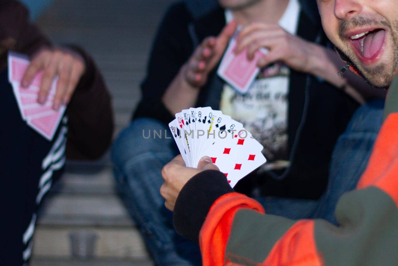 boys playing cards on the steps, gambling