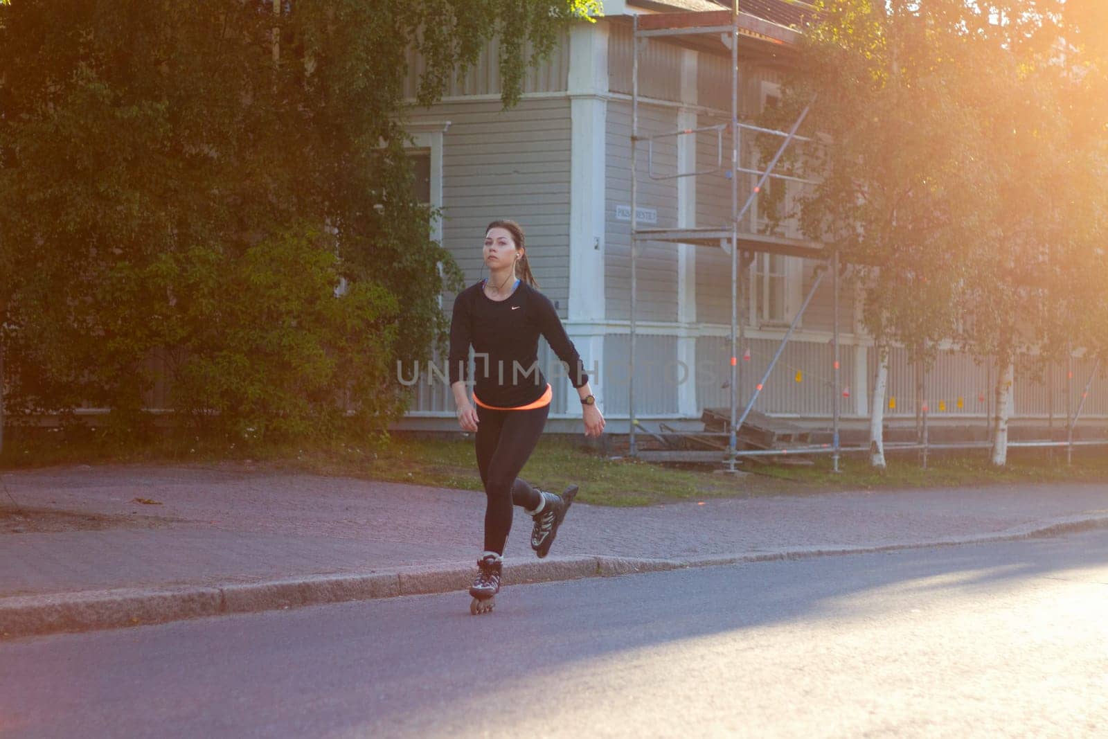 girl on roller skates riding at sunset , sport