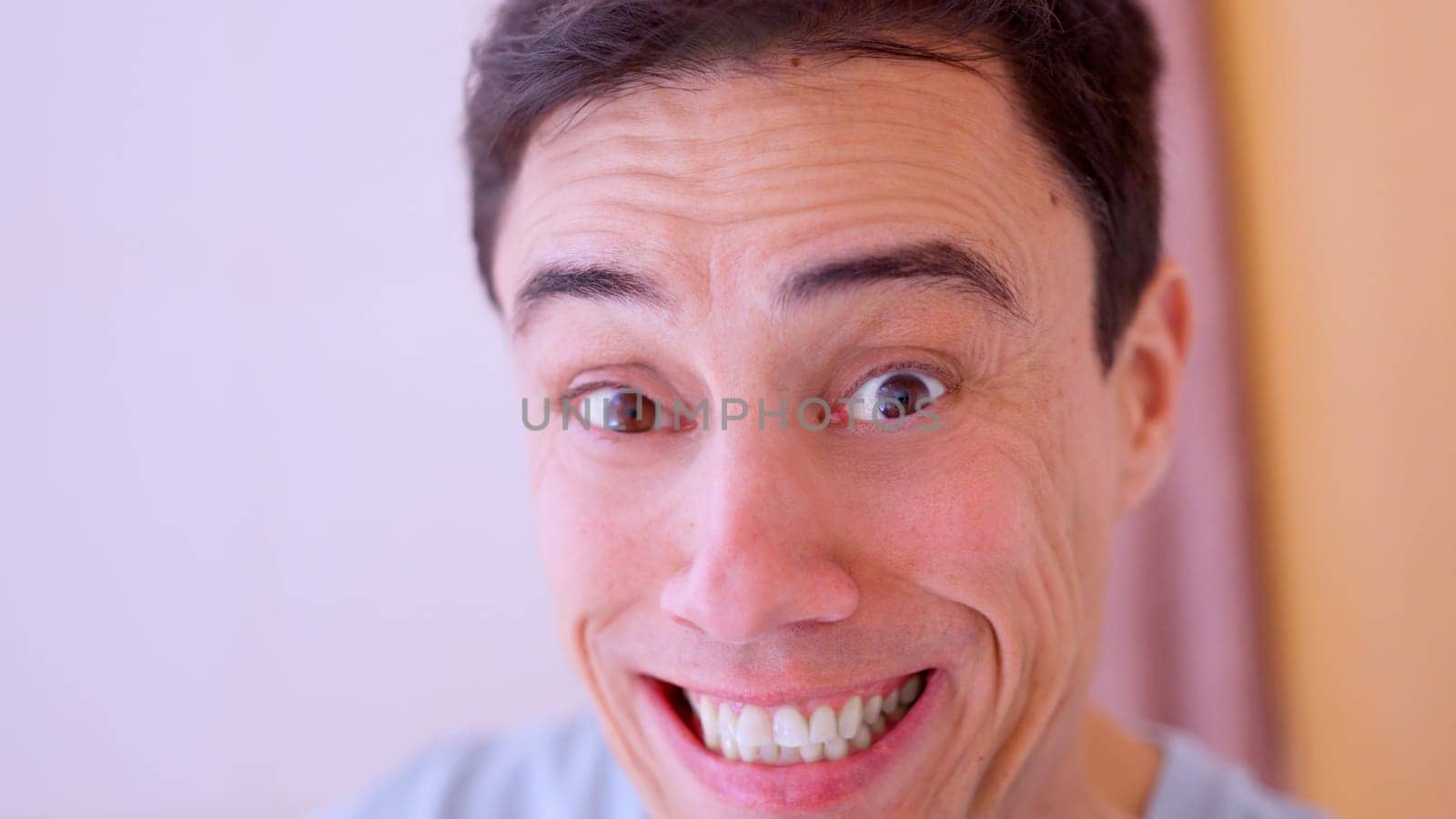Close up of a man making a funny, exaggerated facial expression, conveying humor and lightheartedness