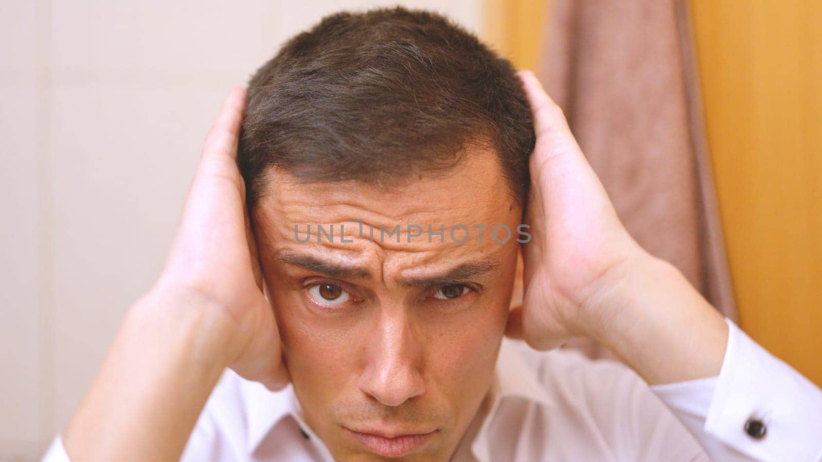 Sexy man getting ready in front of the mirror in the bathroom