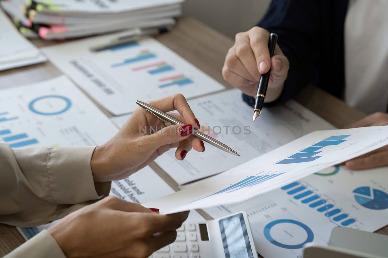 Colleagues review financial reports and data charts, collaborating on budgeting strategies and financial assessments.