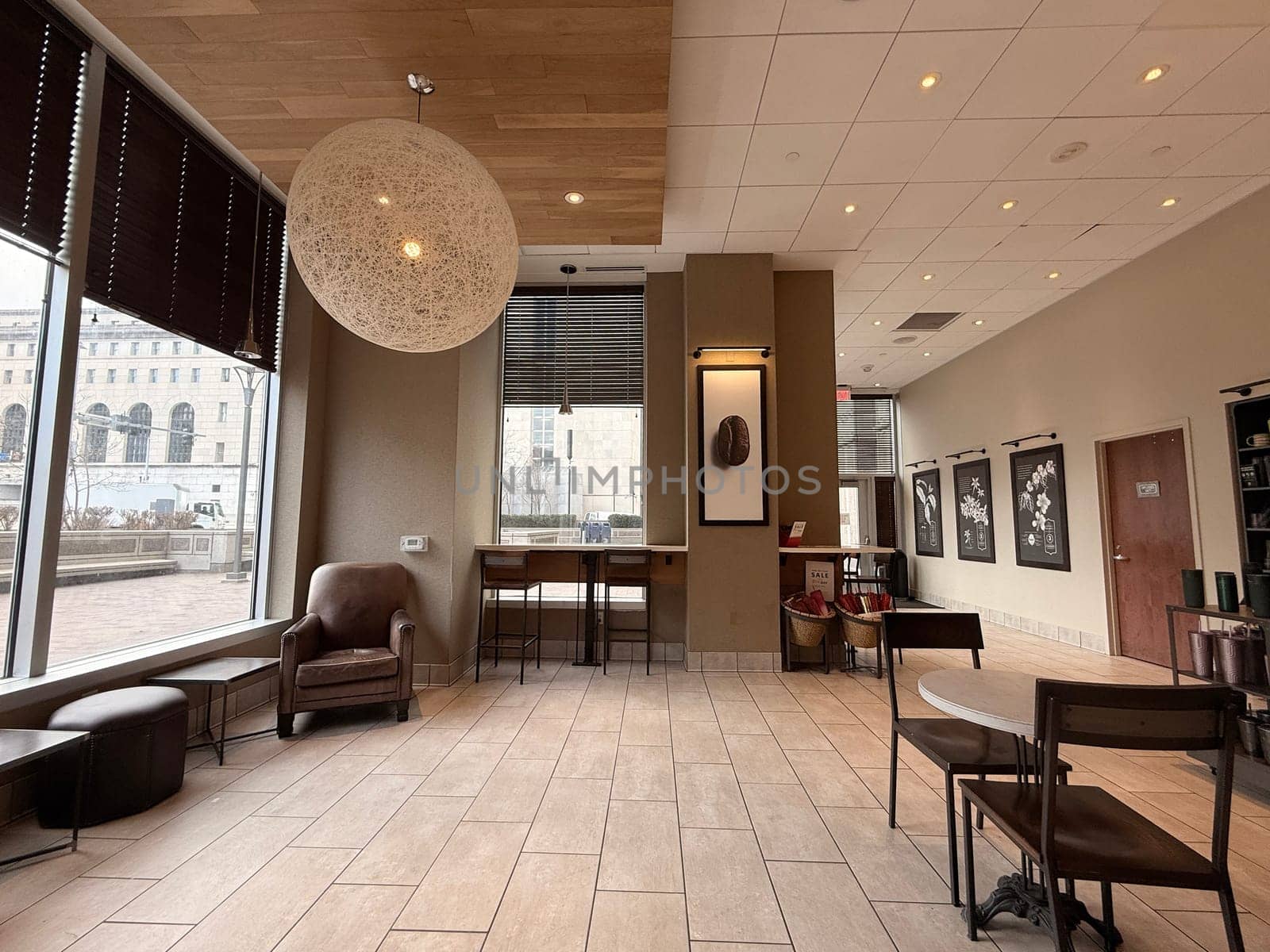 cozy cafe interior featuring stylish furniture, subdued lighting, and a warm, welcoming ambiance ideal for relaxation, conversation, and enjoying a cup of coffee or tea, good for multimedia content creation