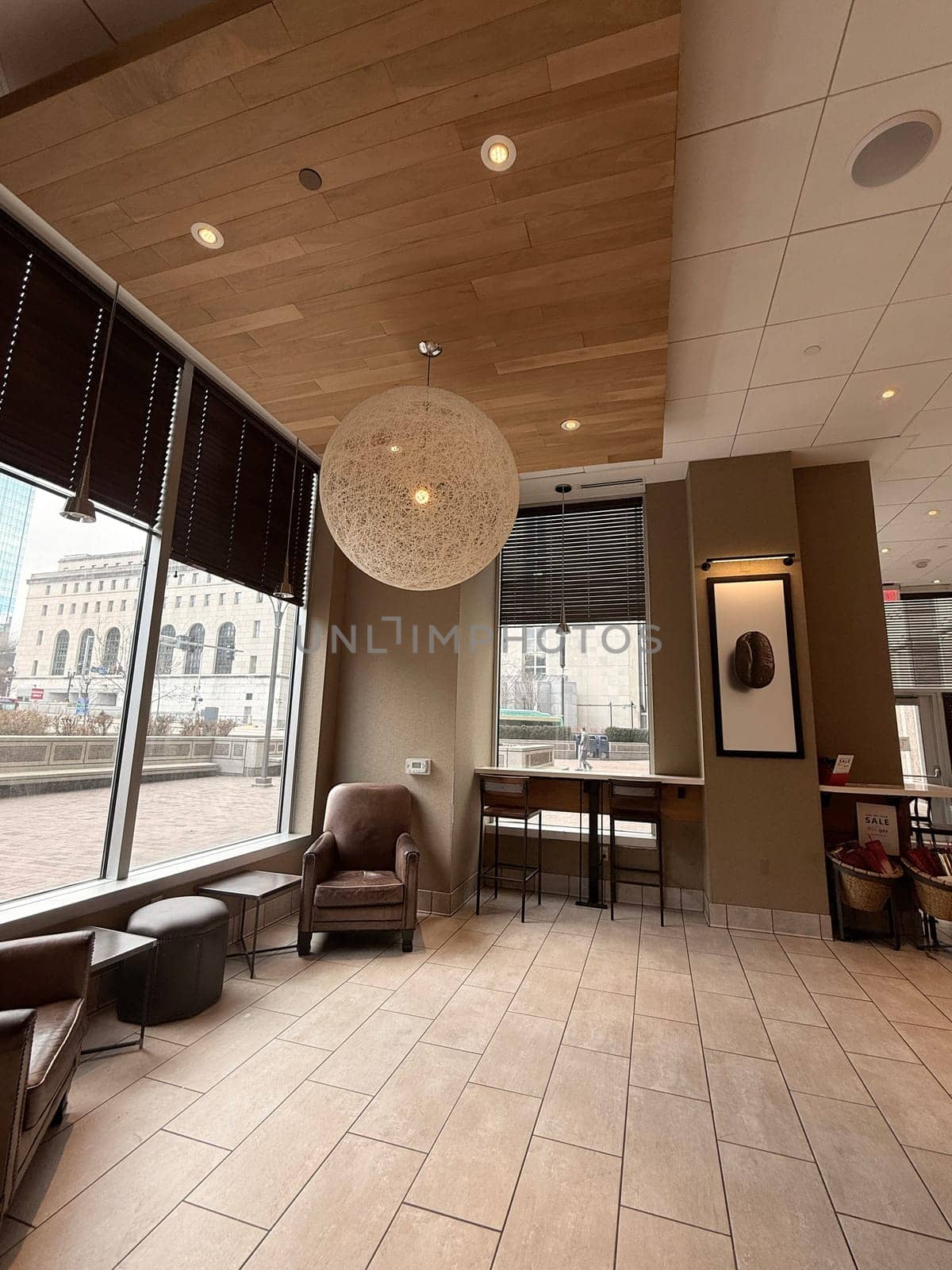 cozy cafe interior featuring stylish furniture, subdued lighting, and a warm, welcoming ambiance ideal for relaxation, conversation, and enjoying a cup of coffee or tea, good for multimedia content creation