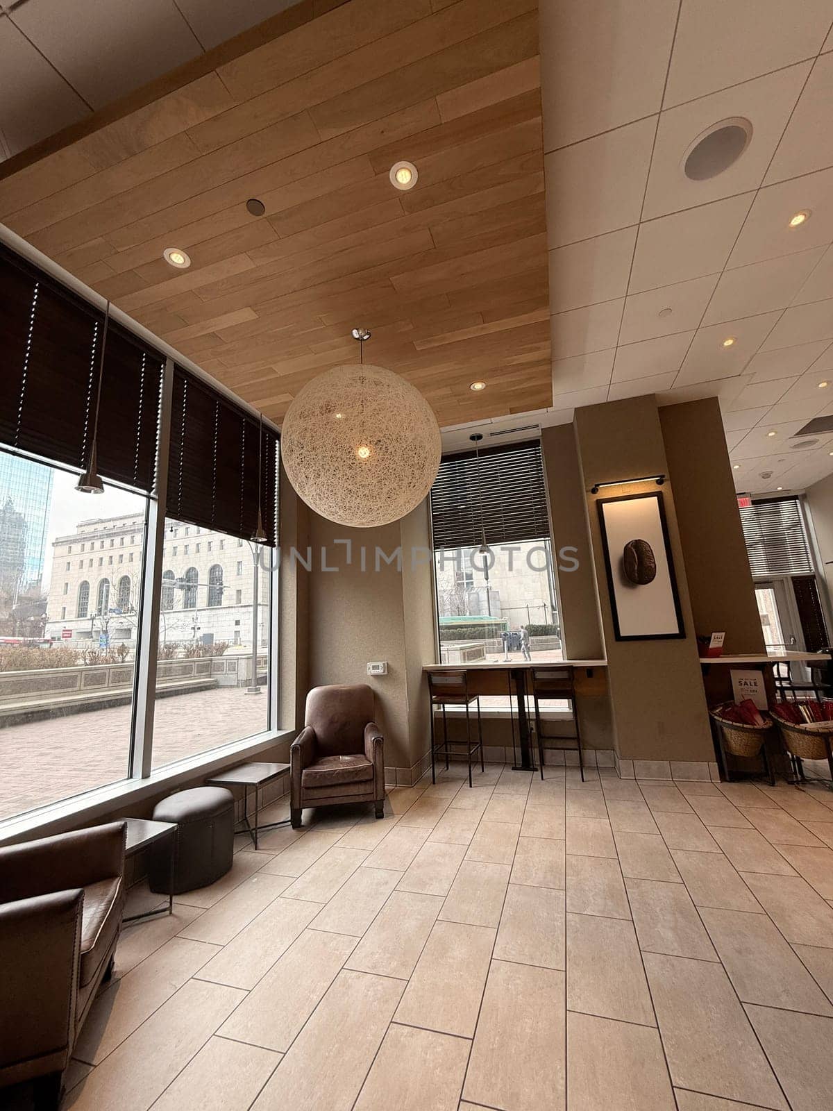 cozy cafe interior featuring stylish furniture, subdued lighting, and a warm, welcoming ambiance ideal for relaxation, conversation, and enjoying a cup of coffee or tea, good for multimedia content creation