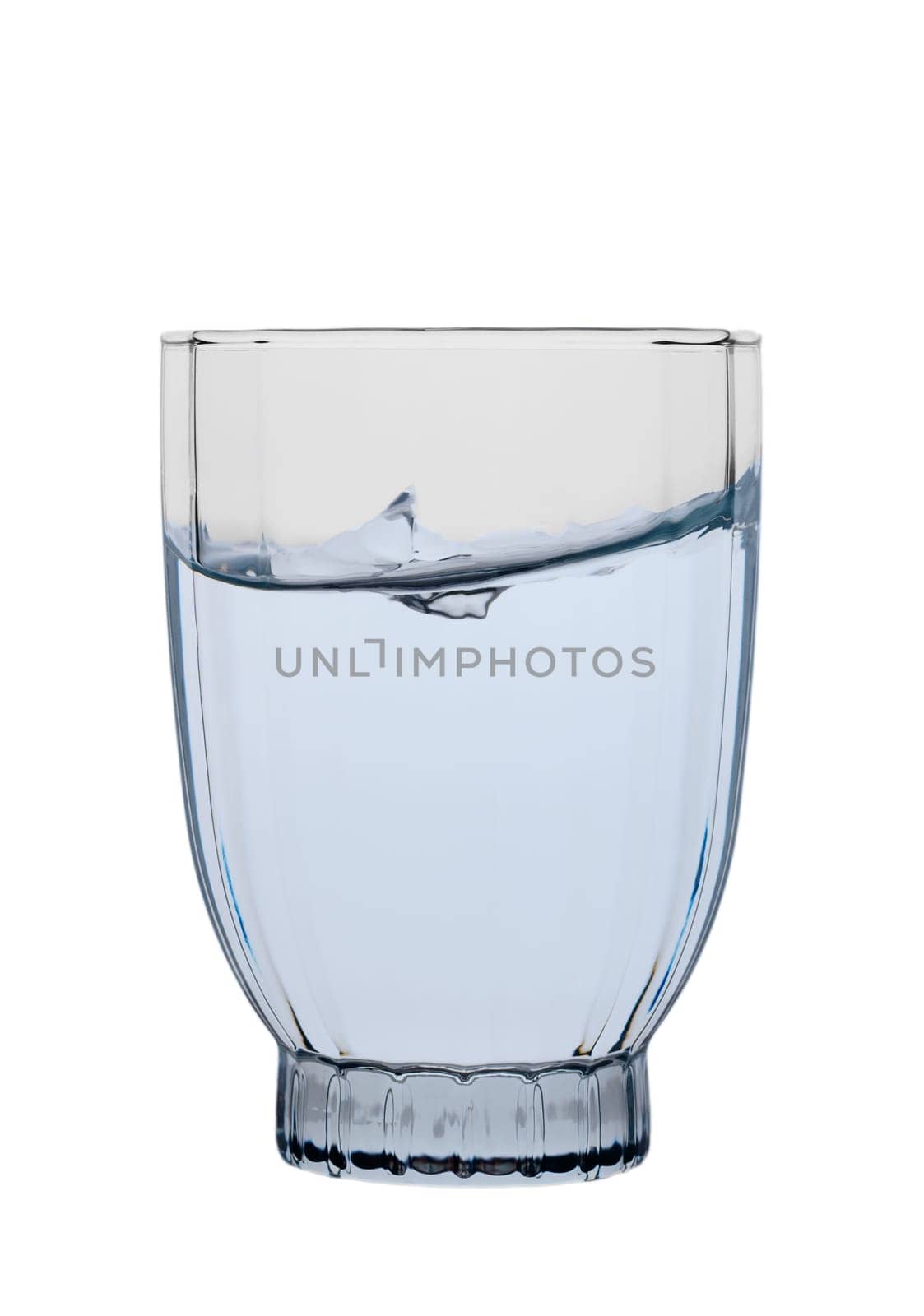 Clear glass holds shimmering water as it ripples, capturing the essence of refreshment and tranquility.