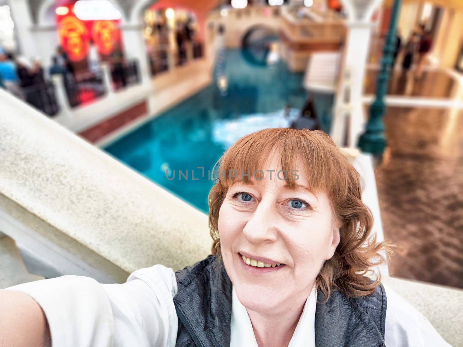 Visitors enjoy Macau's vibrant casinos, buzzing with excitement, near a peaceful water feature.
