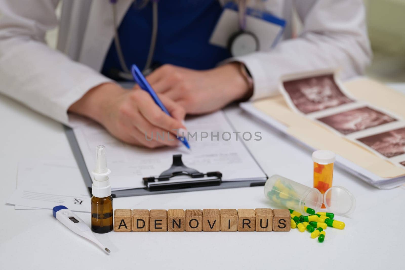 A doctor is analyzing the adenovirus while reviewing medications and documents in a clinical setting
