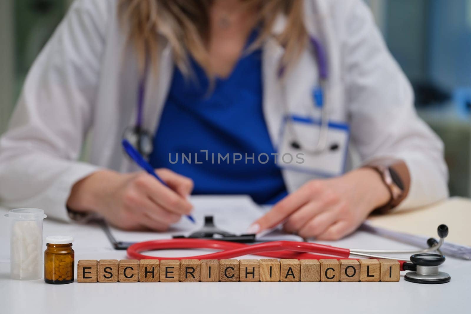 A medical professional diligently studying Escherichia coli while utilizing notes and various laboratory tools