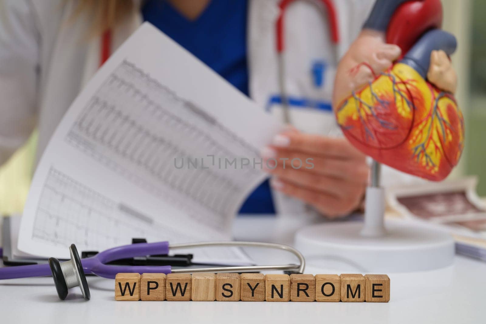 A dedicated medical professional meticulously analyzes WPW syndrome using a heart model and various data sheets