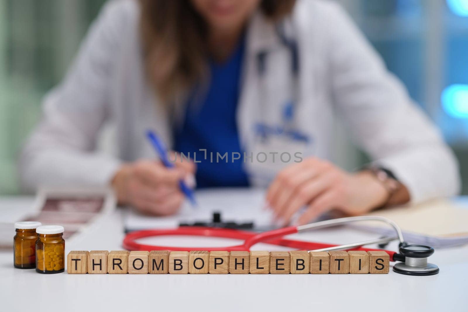 A medical professional is engaging in the study of thrombophlebitis while keeping treatment supplies in view