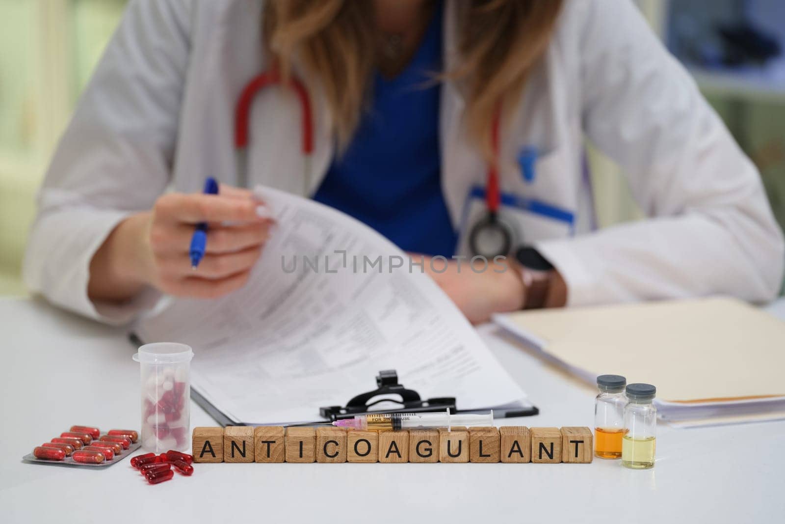 A dedicated healthcare worker analyzes anticoagulant treatments involving medications and paperwork