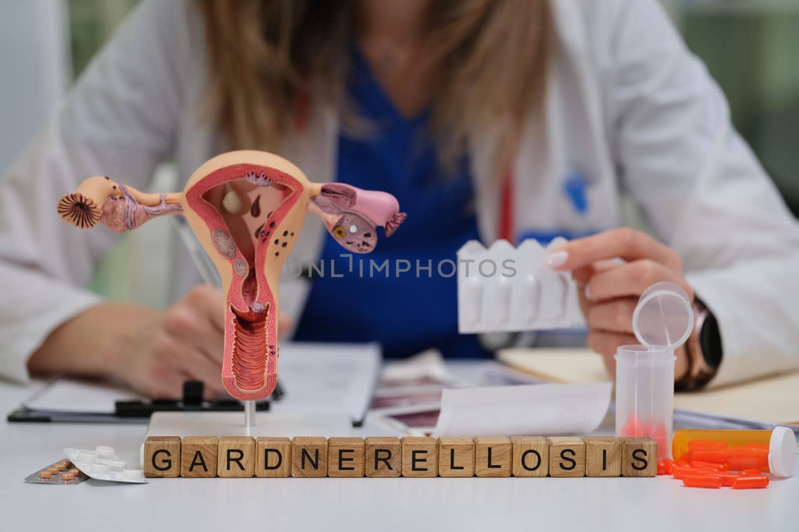 A detailed visual representation of Gardnerella bacteria using an anatomical model alongside medical tools