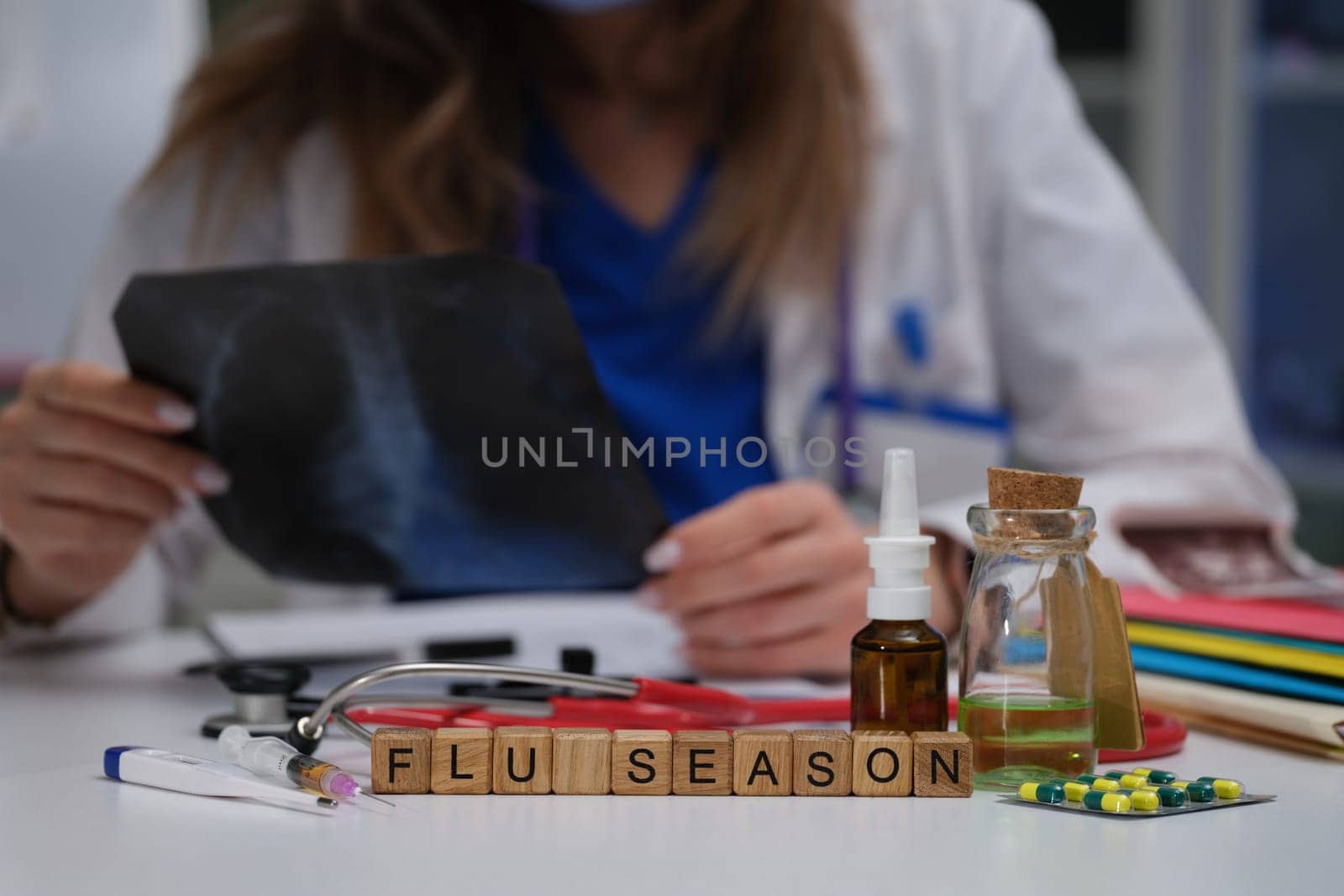 A medical professional carefully examines an Xray, highlighting the importance of flu season preparedness