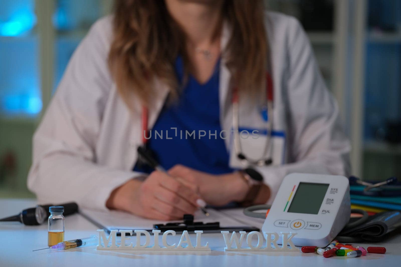 A dedicated healthcare professional dressed in medical scrubs is effectively working with essential medical equipment