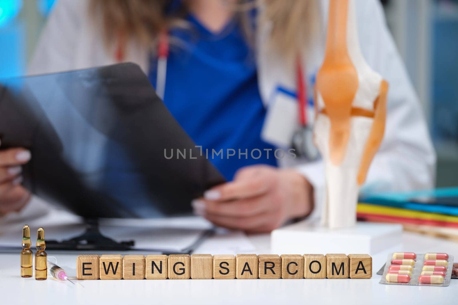 A dedicated healthcare professional thoroughly reviews Ewing Sarcoma related educational materials and anatomy models