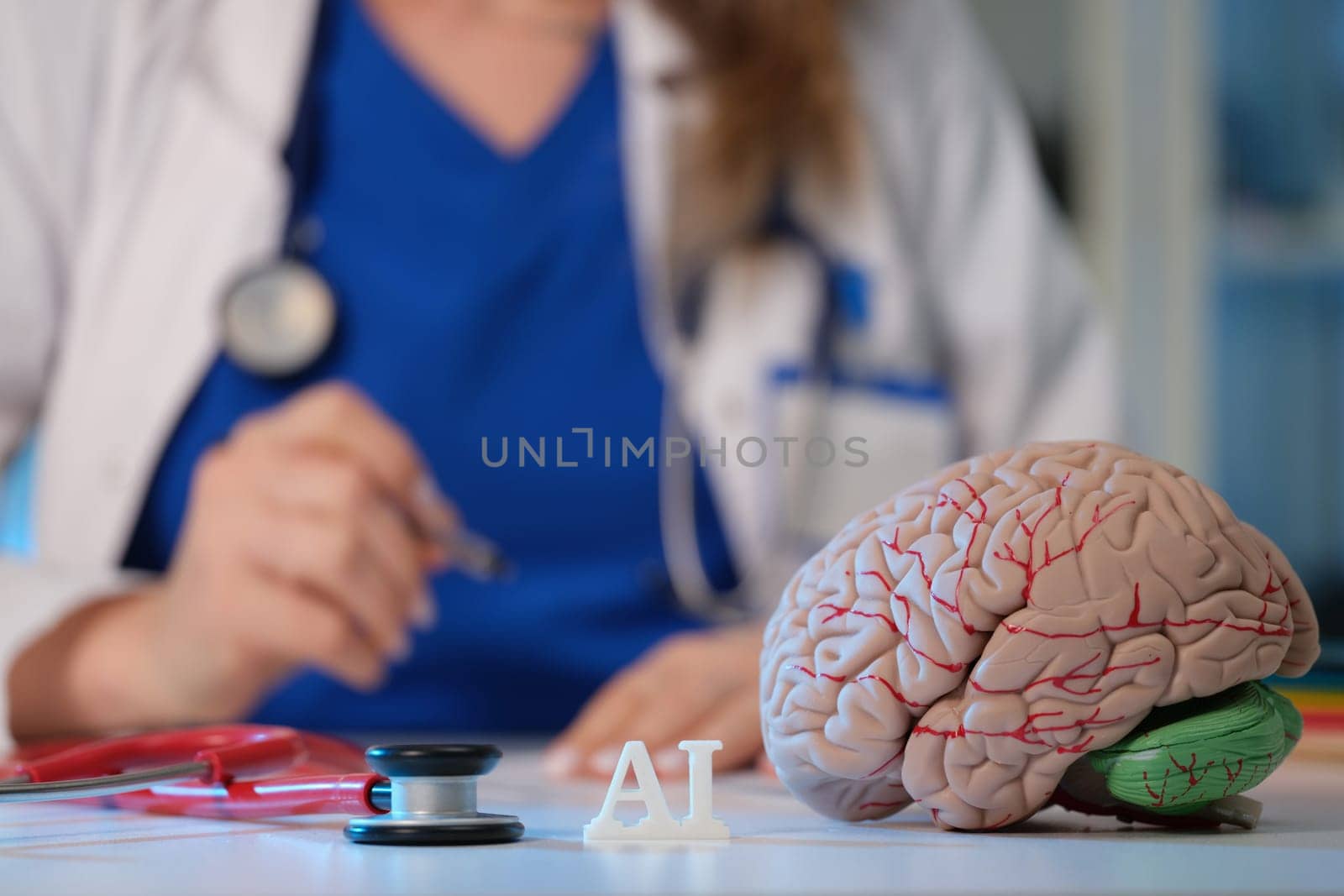 A healthcare professional examines a brain model enhanced with advanced AI technology in modern medicine
