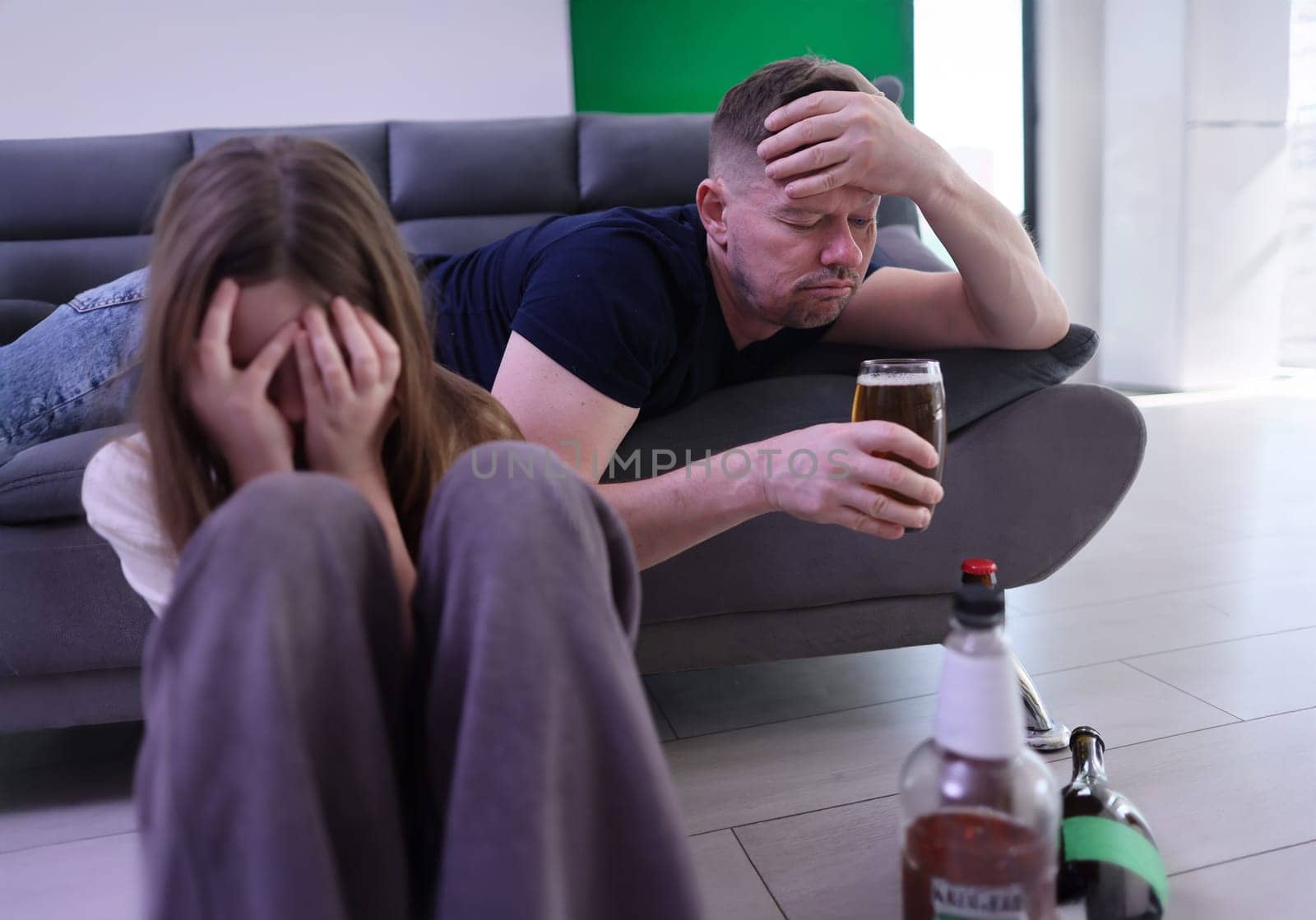 A somber scene capturing the deep emotional impact of alcohol dependency on individuals and their relationships