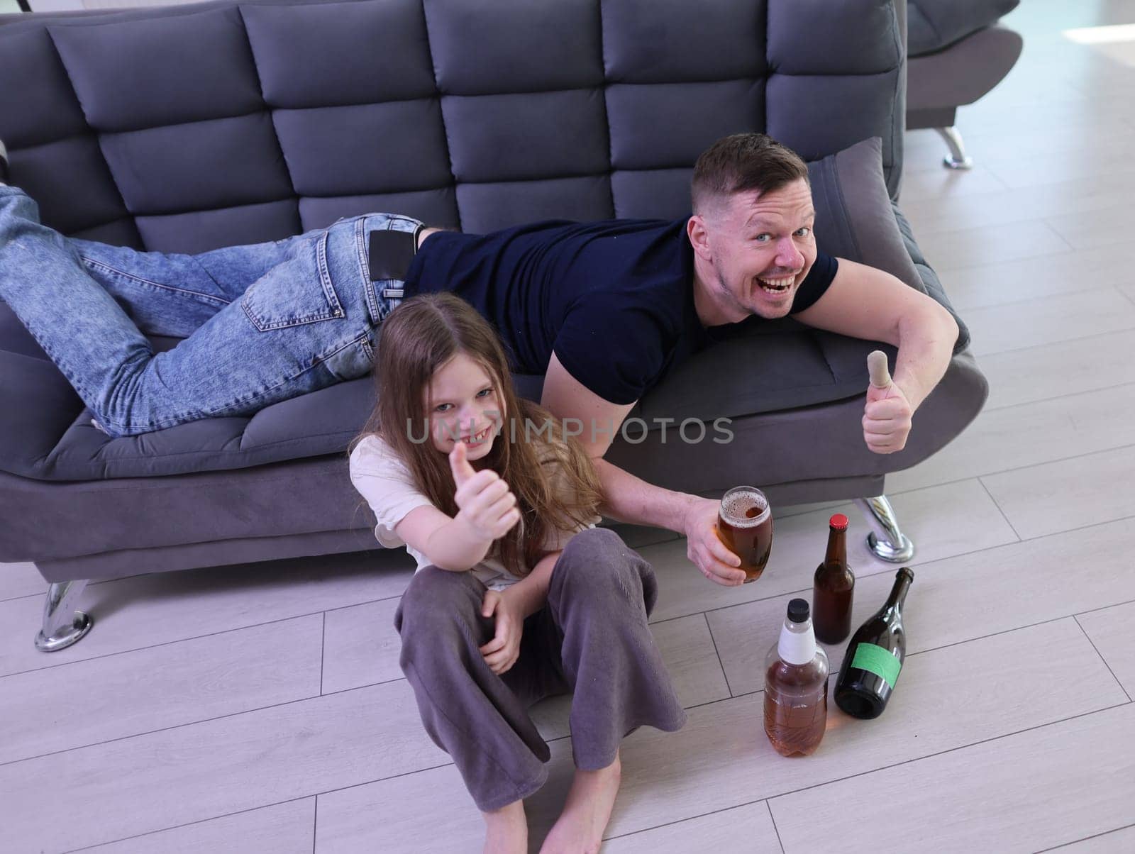 A joyful family moment filled with drinks, cheerful thumbs up, and perfect relaxation while sitting on the couch