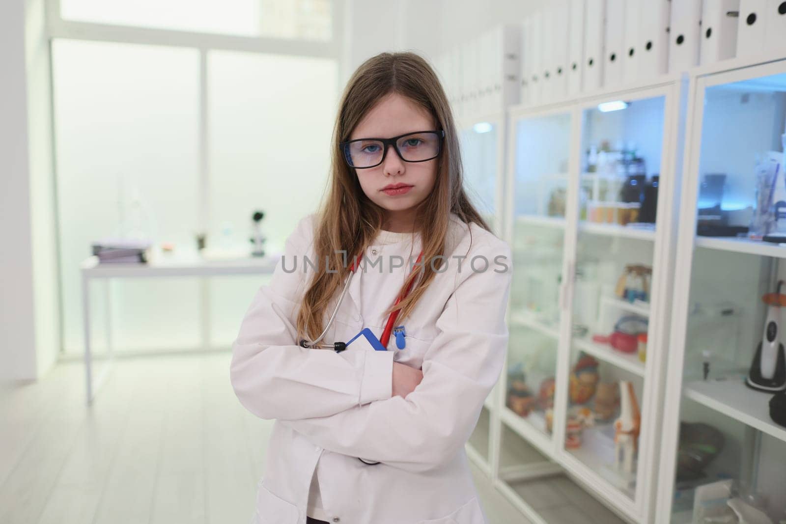 A young girl dressed as a scientist in a modern laboratory setting, showcasing curiosity and intelligence.