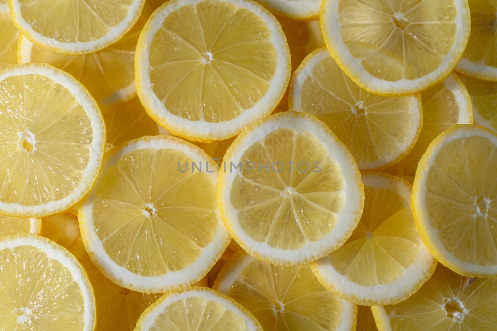 Lemon slices showcase their juicy, yellow interior, perfect for adding zest to drinks and dishes.