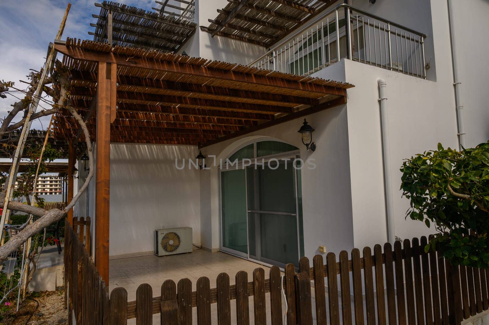 An inviting outdoor area with a wooden trellis offers a tranquil space for relaxing in nature.