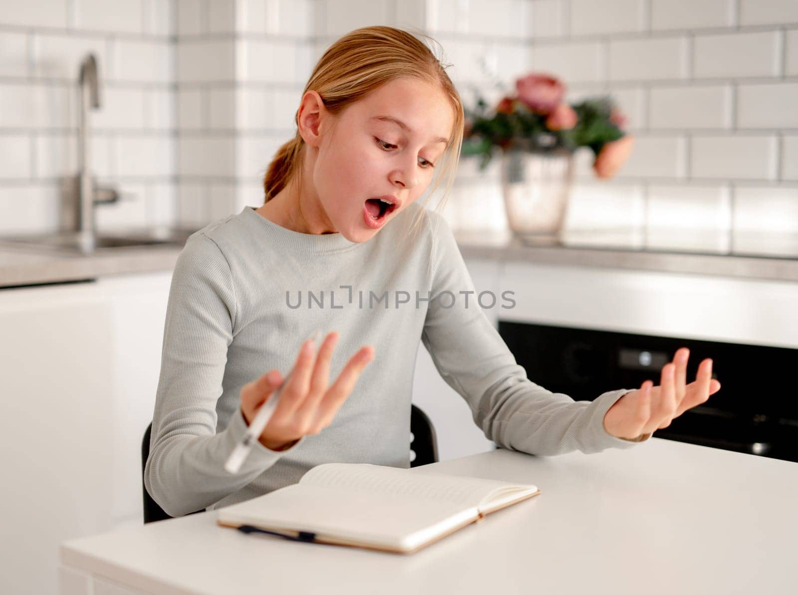 Cute Little Girl Doing Homework Looks Surprised