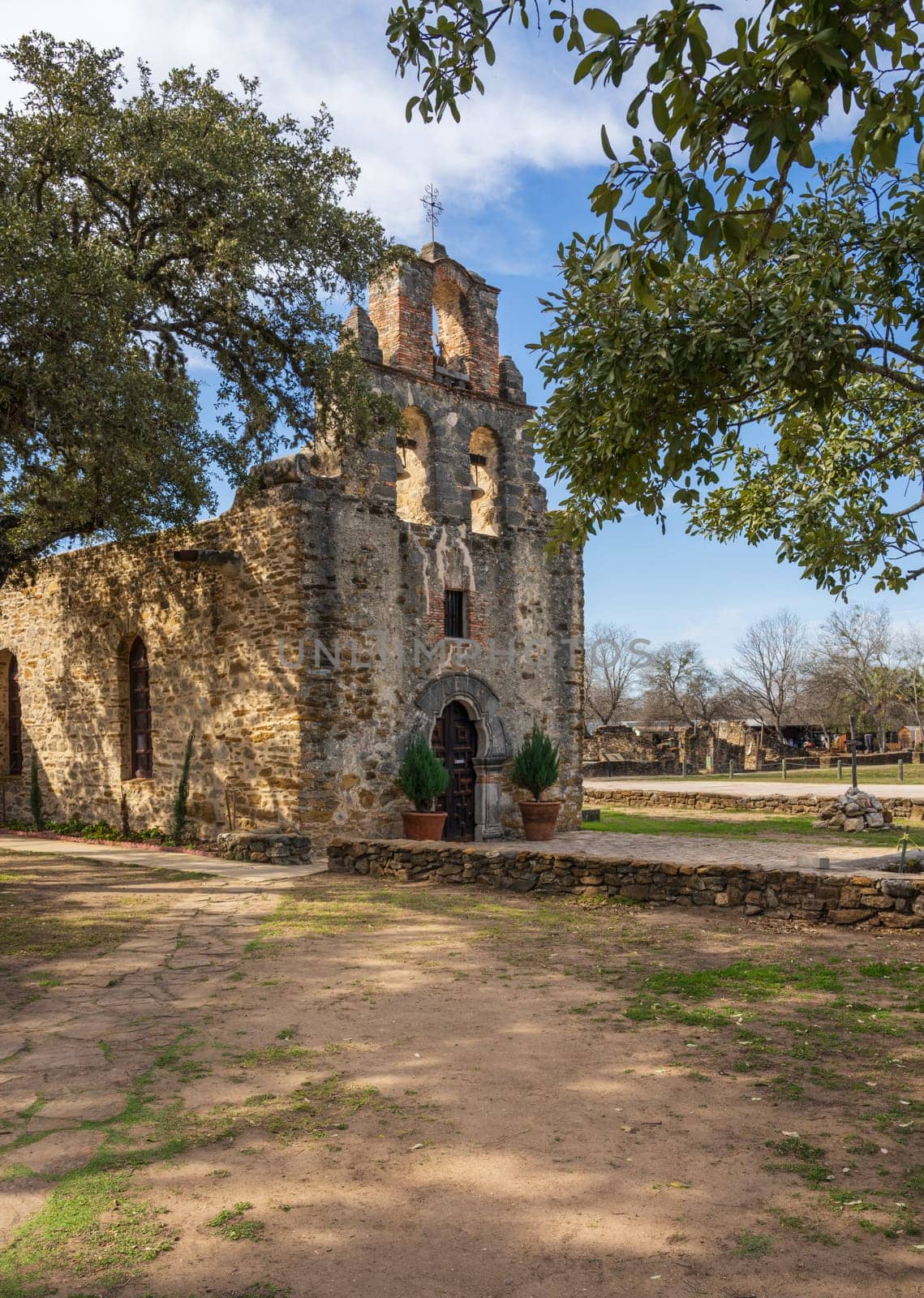 Espada mission church is a historic landmark near San Antonio, Texas, showcasing its weathered facade under a clear sky.