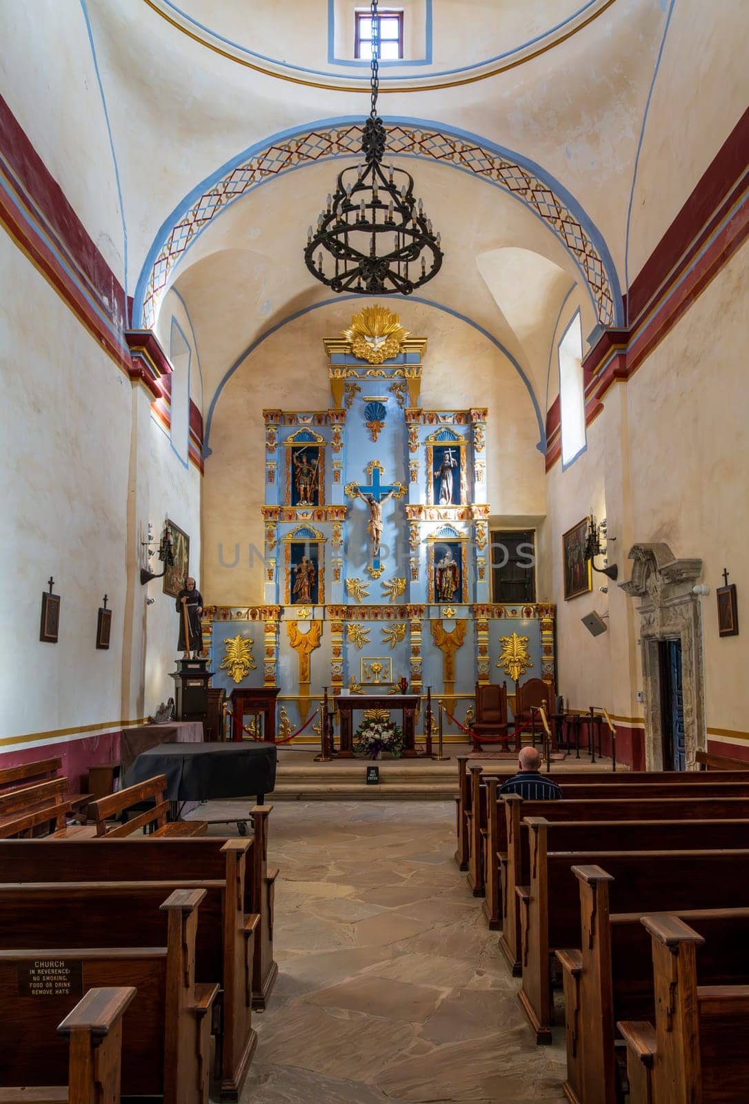 Interior of historic San Jose mission church near San Antonio, Texas, with ornate altar and statues