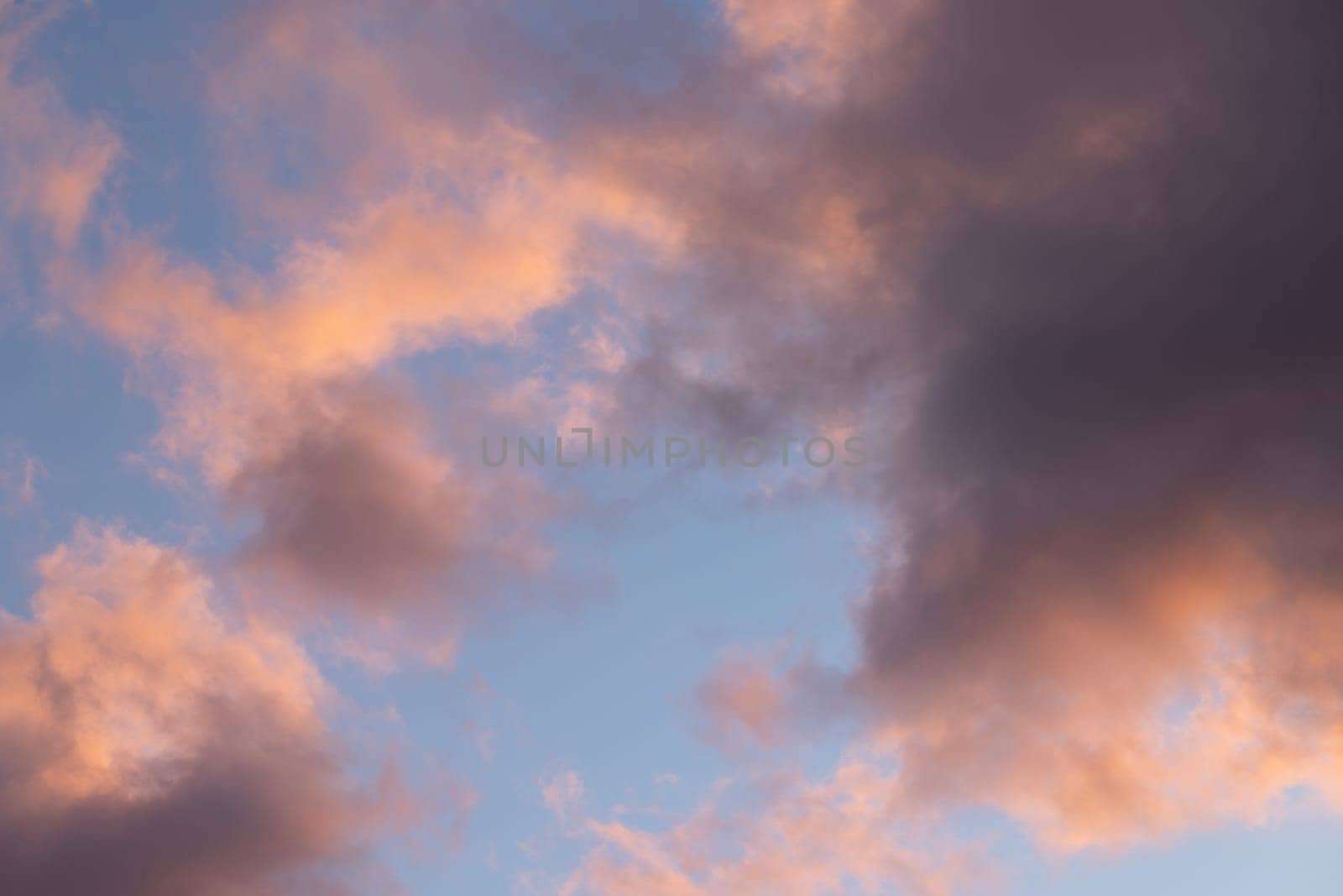 Beautiful pastel colors paint the clouds at sunset, creating a mesmerizing view of the evening sky
