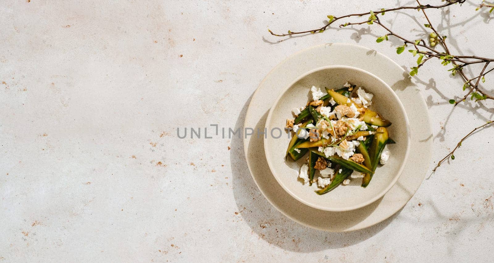 Asian Quick Pickled Cucumbers in Salad. Delicious salad with Asian style pickles cucumbers, goat cheese and walnuts nuts. Ideas and recipes for healthy breakfast, lunch or dinner. Top view or flat lay