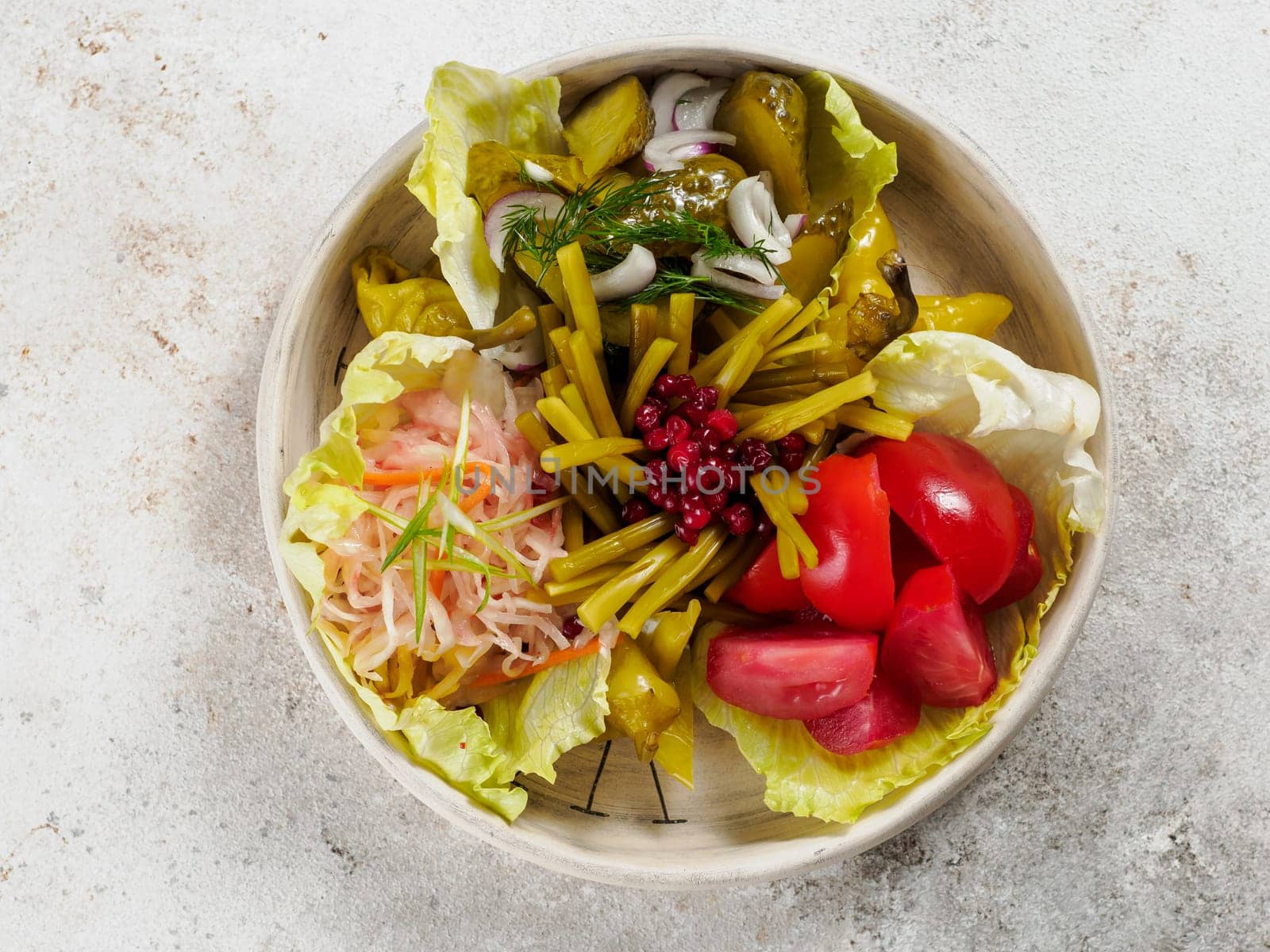 Assorted snacks from fermented cabbage, cucumbers and tomatoes, green bean. Decorated cranberry. Fermented healthy food concept. Pickled cucumbers, marinated tomatoes, Top view or flat lay.