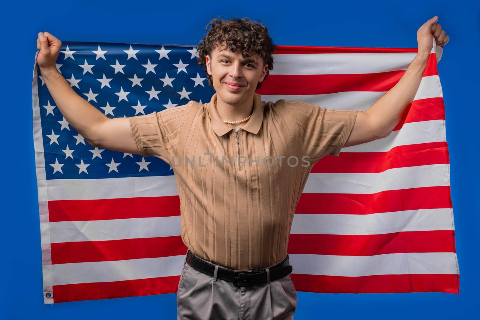 Happy man with national USA flag on blue background. American patriot, 4th of July - Independence day celebration, election, America, labor. US banner. High quality