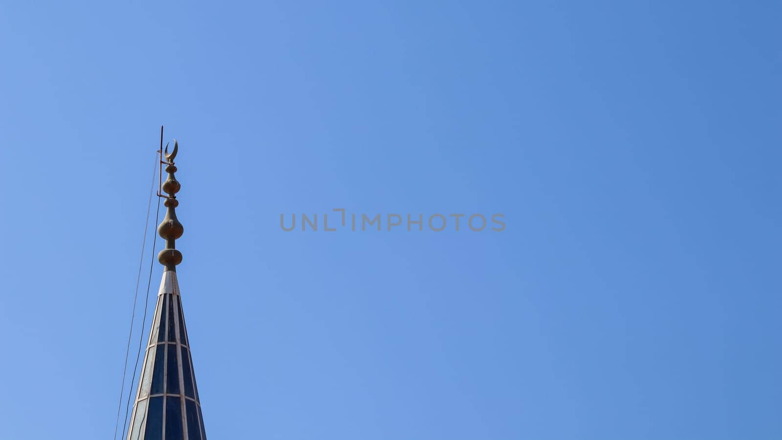 Mosque Minaret on a background of blue sky in Bitez, Bodrum, Turkiye