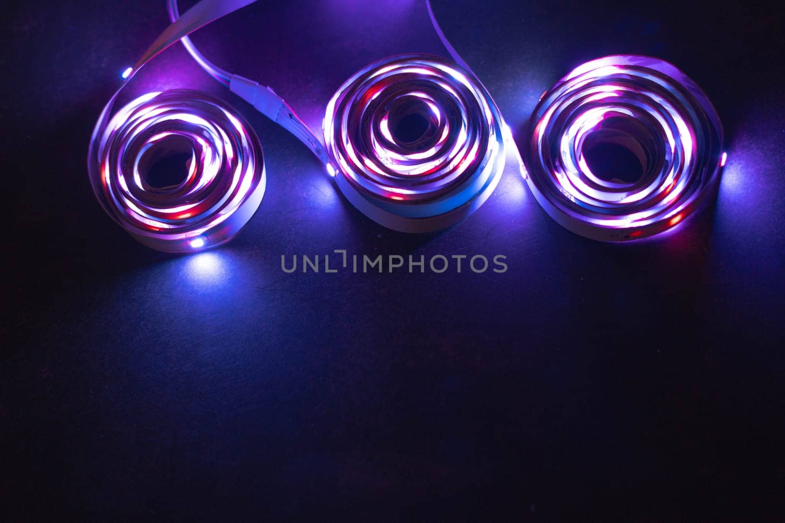 This captivating image showcases vibrant LED spirals against a dark surface, highlighting unique patterns and colors that create a dynamic visual appeal.