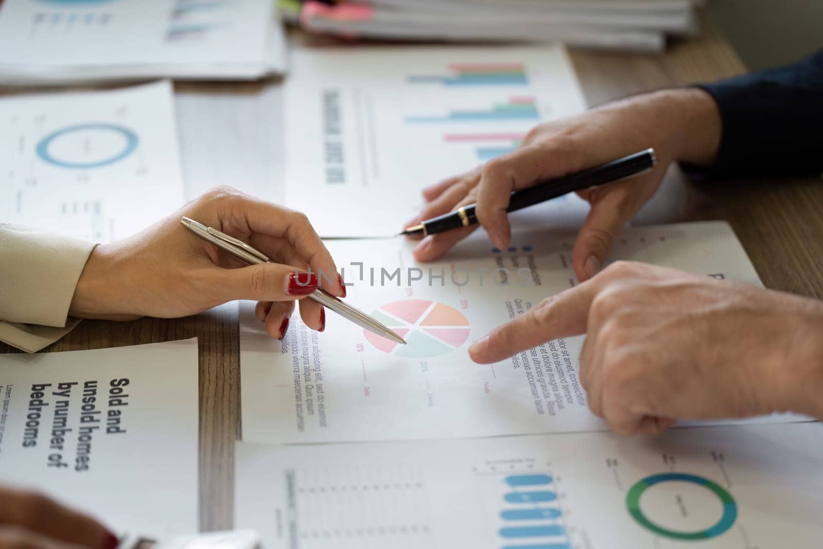 Team members engage in collaborative financial analysis, reviewing charts and reports to drive informed decisions.
