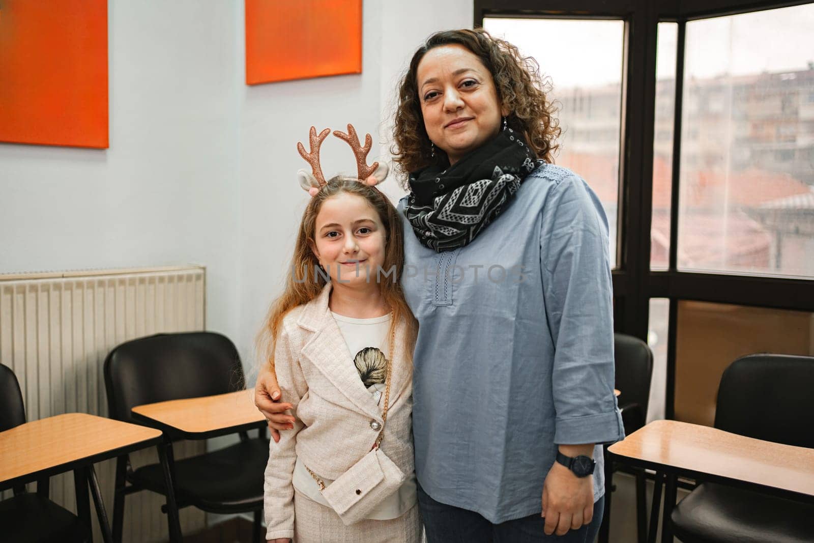Female teacher with elementary student at language school class.