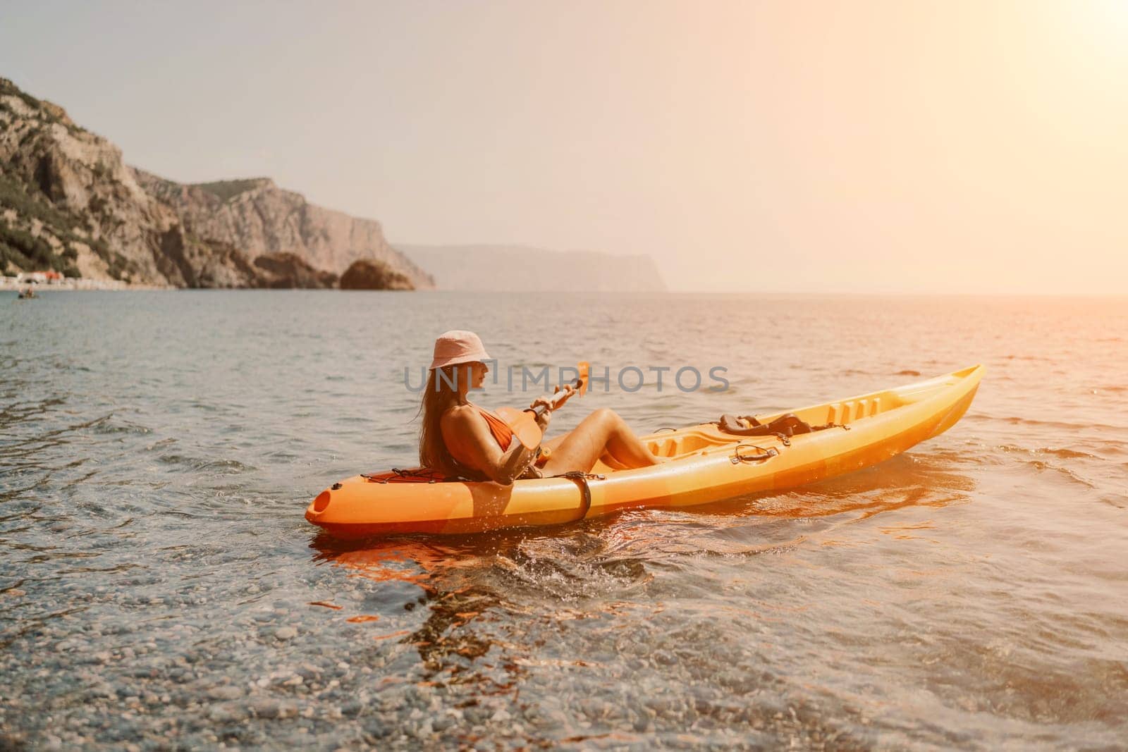 Kayak sea woman. Happy attractive woman with long hair in red swimsuit, swimming on kayak. Summer holiday vacation and travel concept
