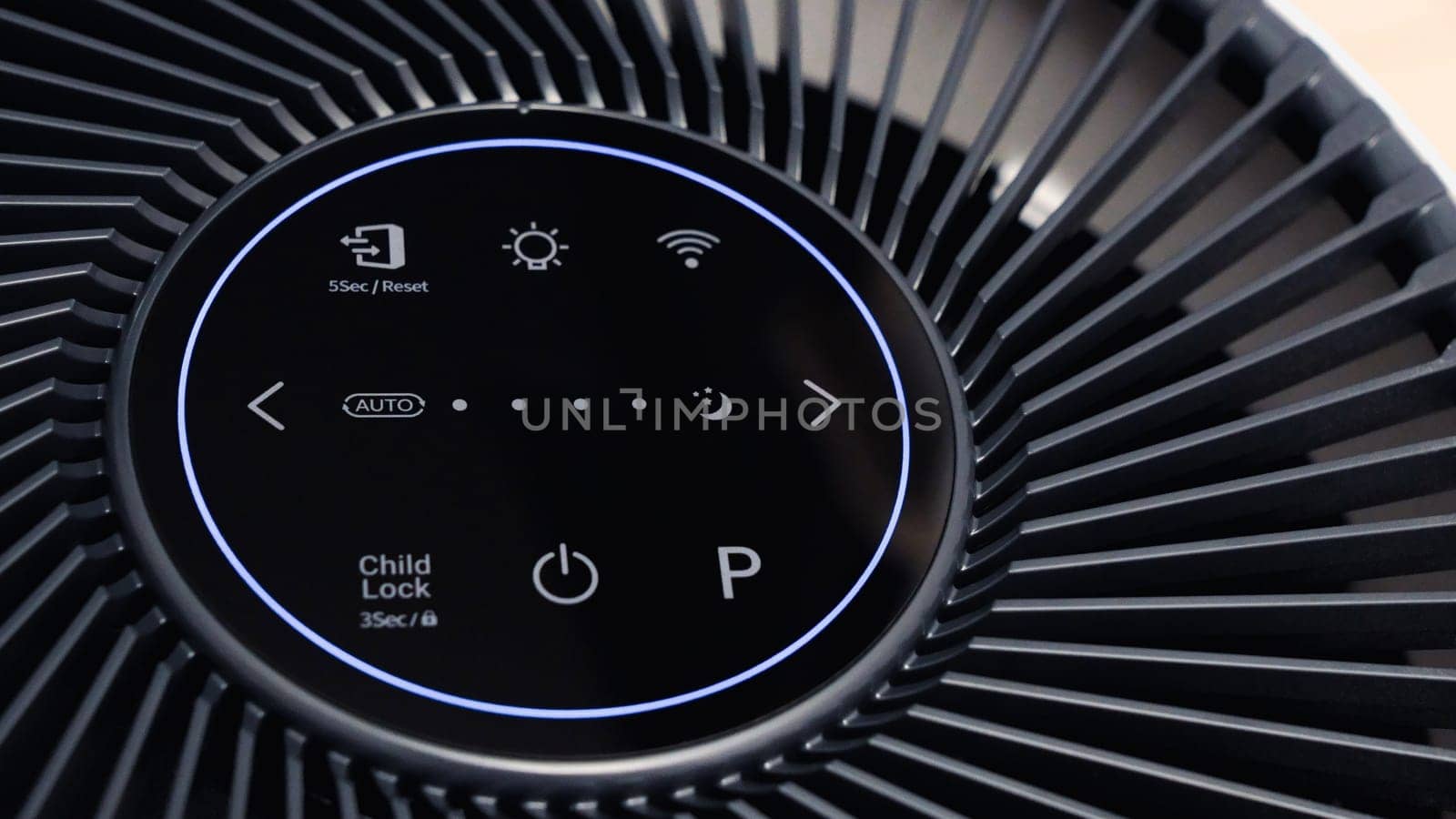 Close up view of Air Purifier with Black Fan. Black Round Electronic Device with Buttons and Bright Lights on White Background.