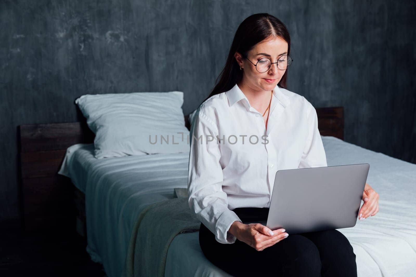 Woman working on laptop online at home