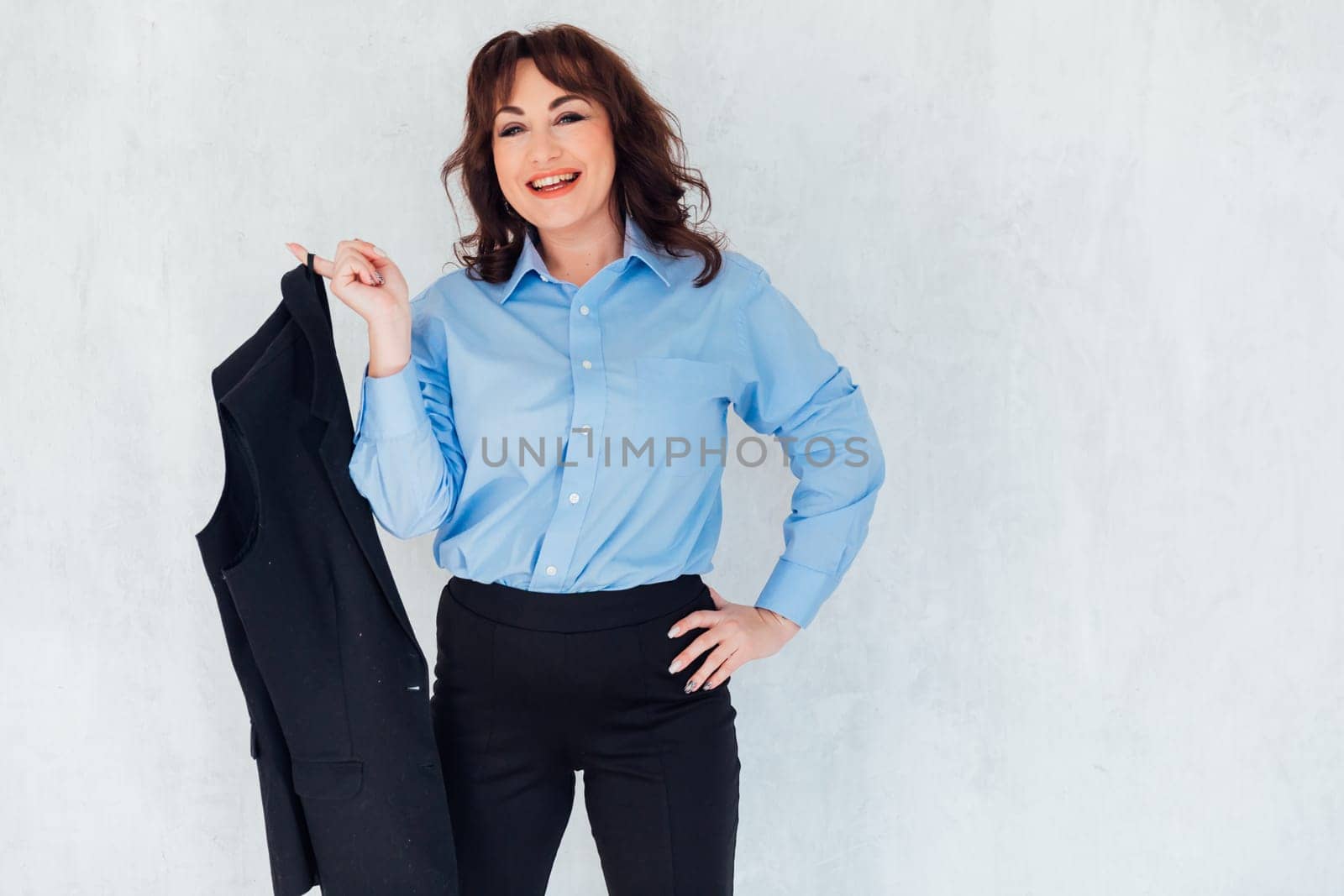 Portrait of a beautiful woman in a gray blue suit