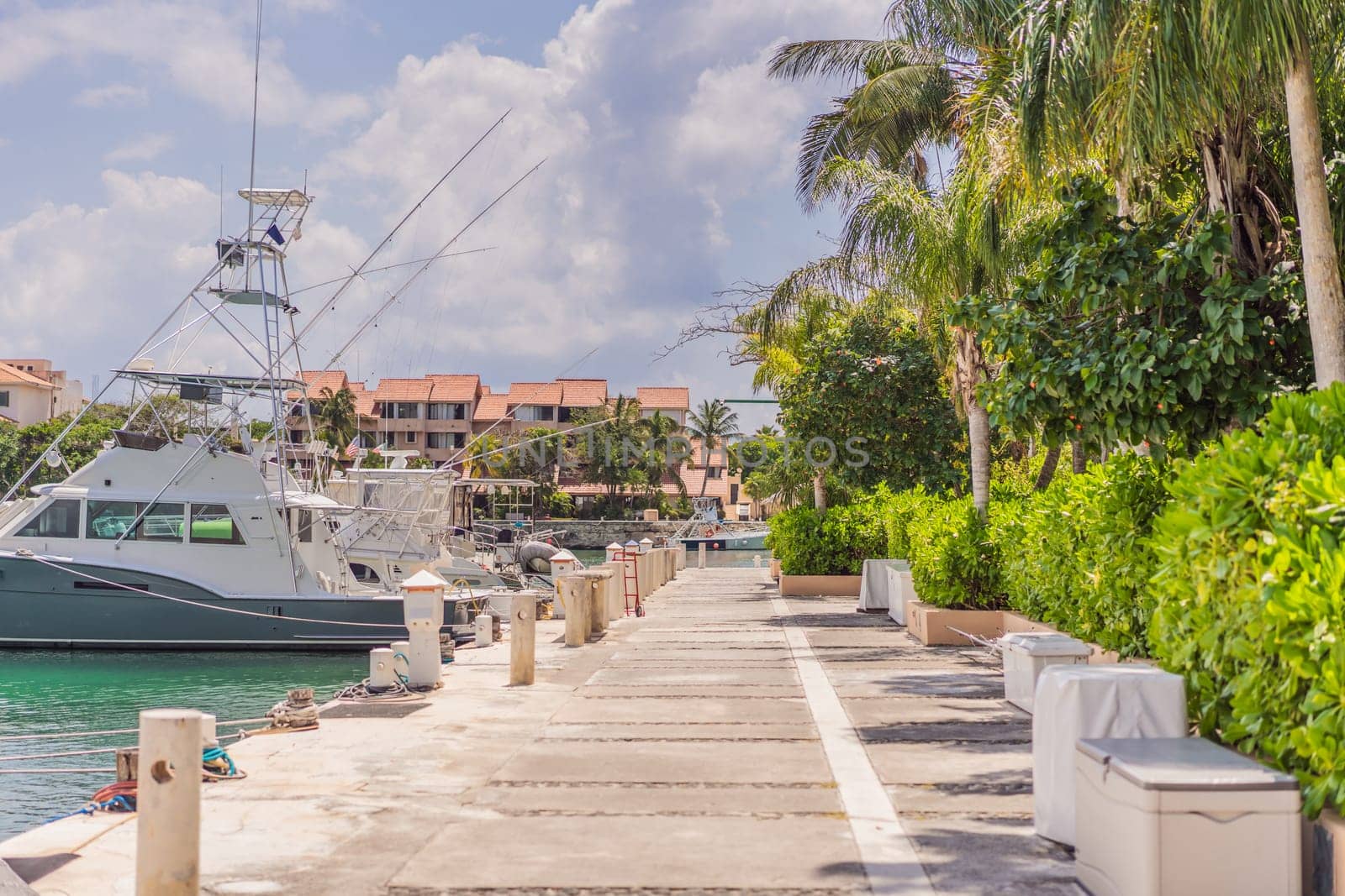 A scenic marina filled with luxurious yachts docked in calm waters, reflecting the beauty of a coastal lifestyle. A serene and elegant setting representing travel, wealth, relaxation, and nautical adventures.