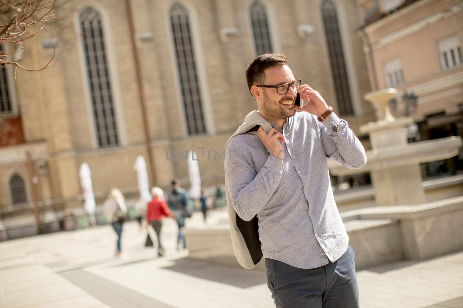 Handsome young man using mobile phone outdoor