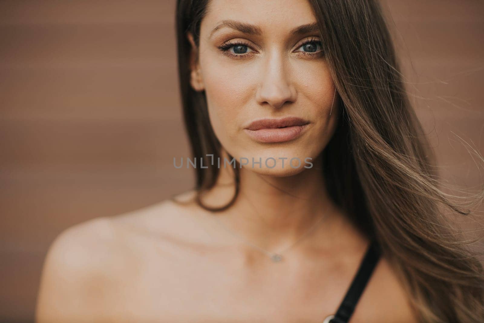 Outdoor portrait of sensual long hair brunette woman