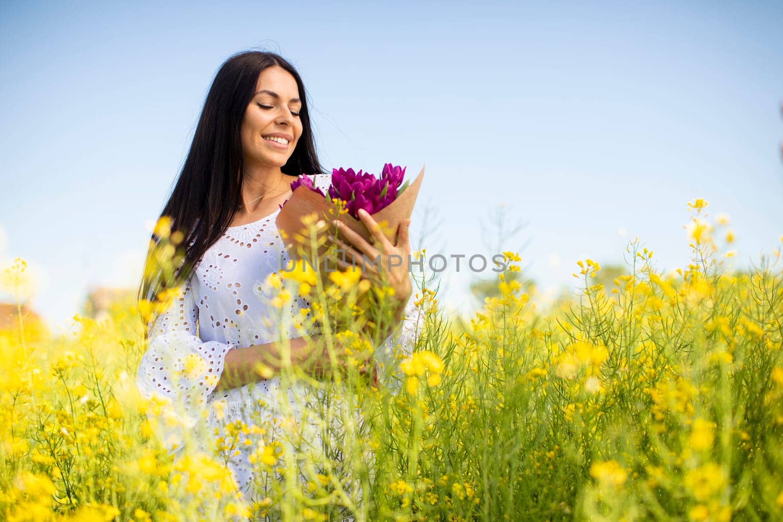 Pretty young woman in the rapeseed field