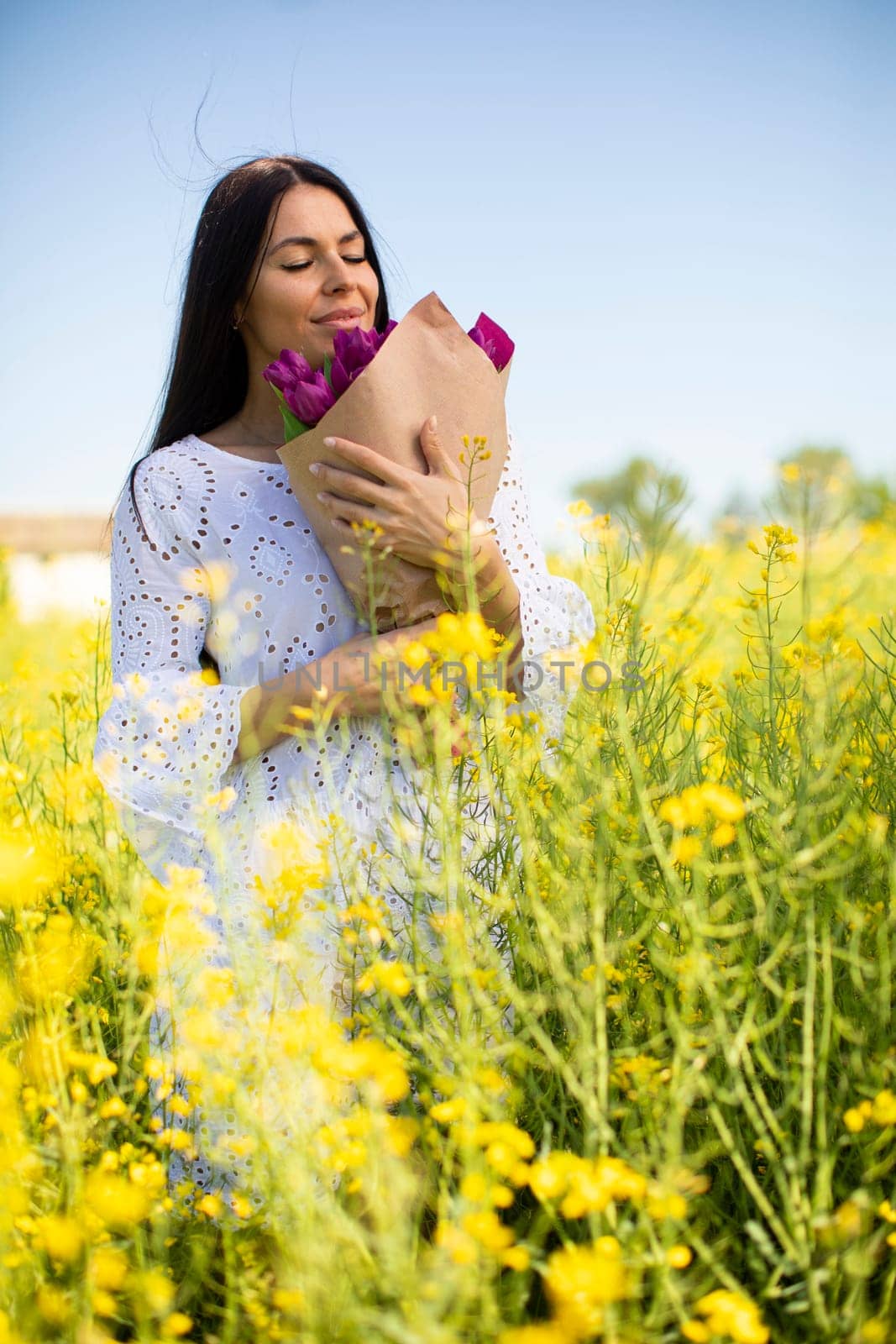 Pretty young woman in the rapeseed field