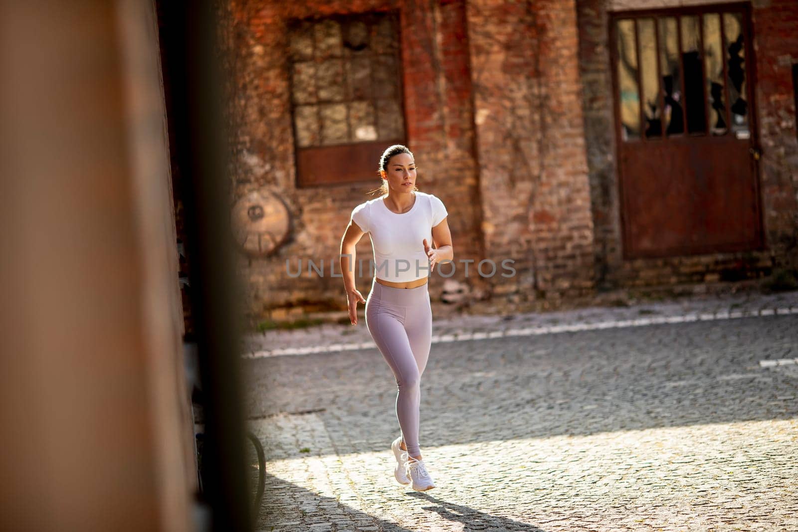 Pretty young woman running on the street