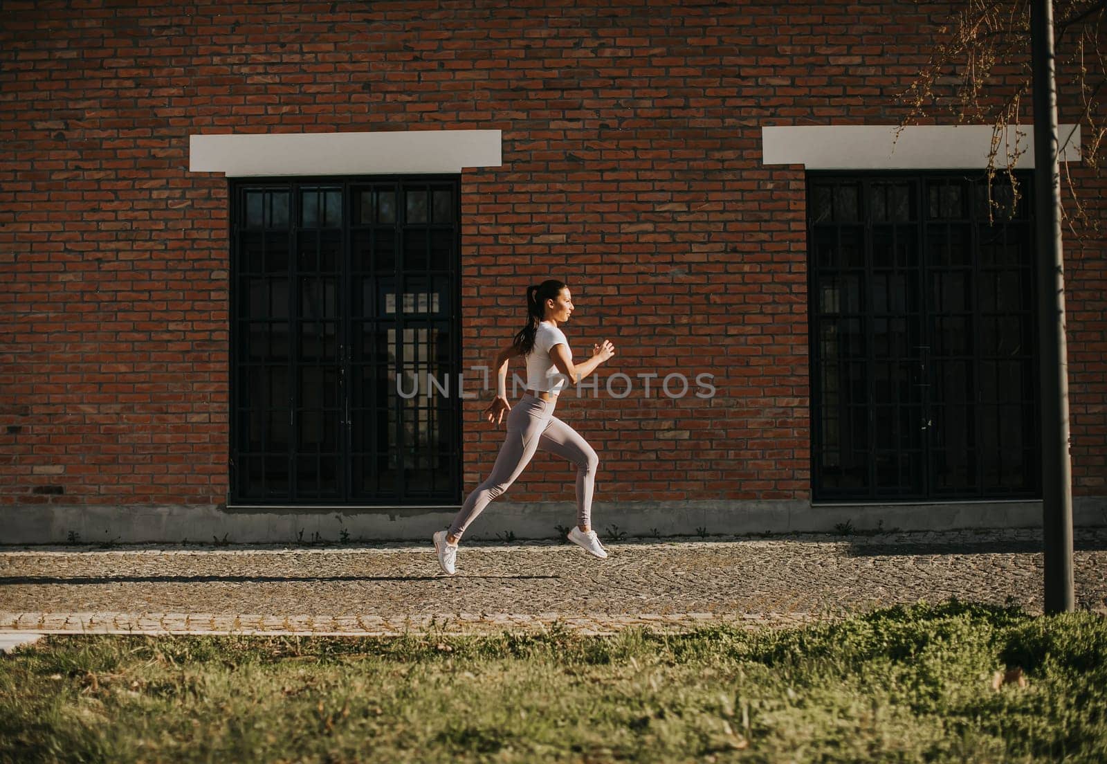 Handsome young couple running in the urban environment