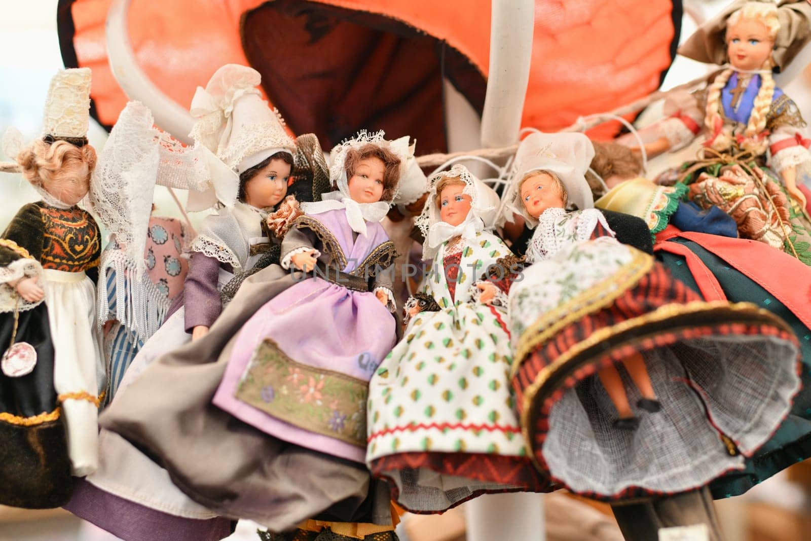 Lots of different Provencal, Breton vintage French dolls in national costumes at a flea market