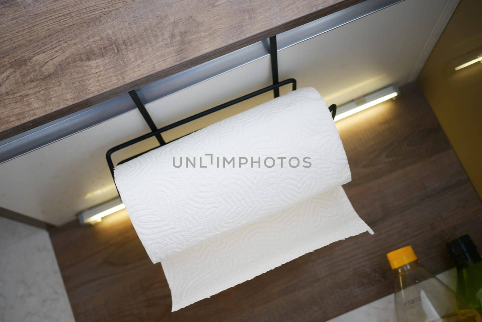 An overhead view of a paper towel holder in a modern kitchen space.